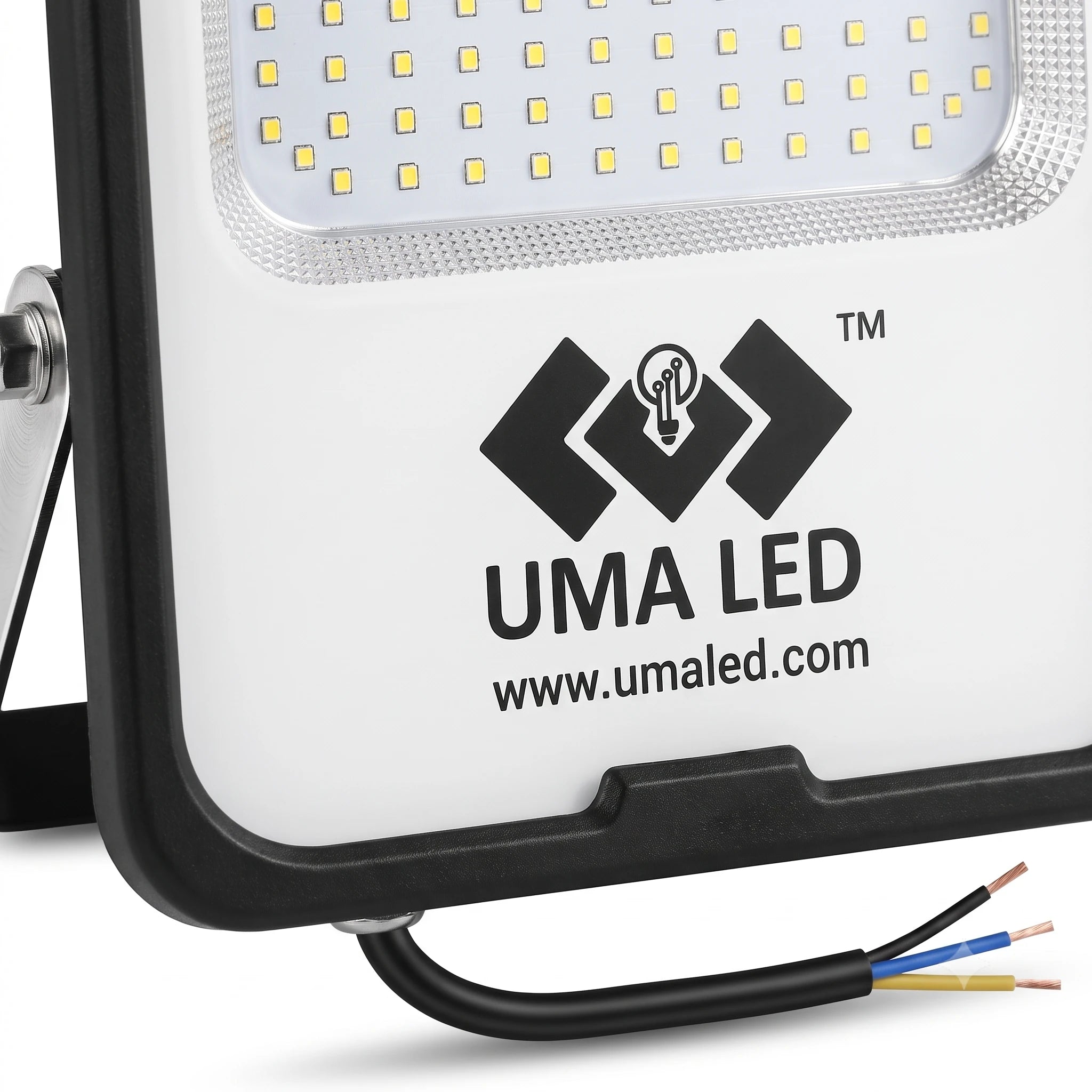 Close-up of a white and black UMA LED floodlight showing the front LED panel, printed logo, and three exposed wire leads on a white background.