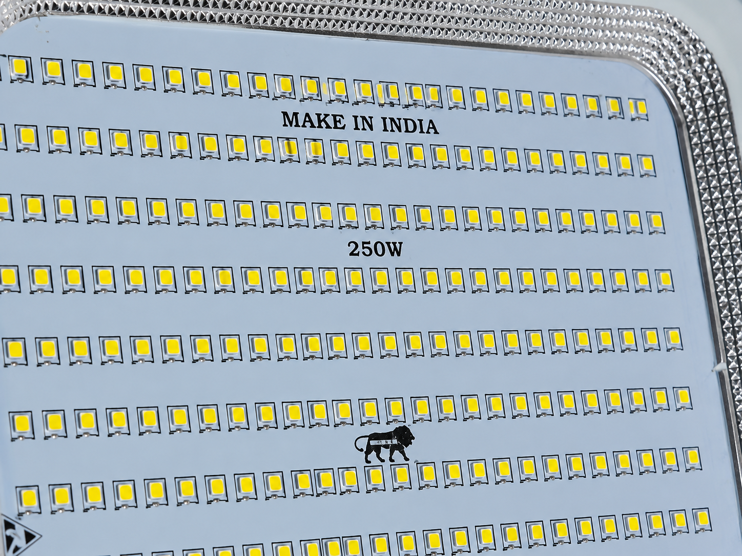 Close-up of a 250W LED light panel with rows of yellow LED chips on a silver base, featuring 'MAKE IN INDIA' and '250W' text.