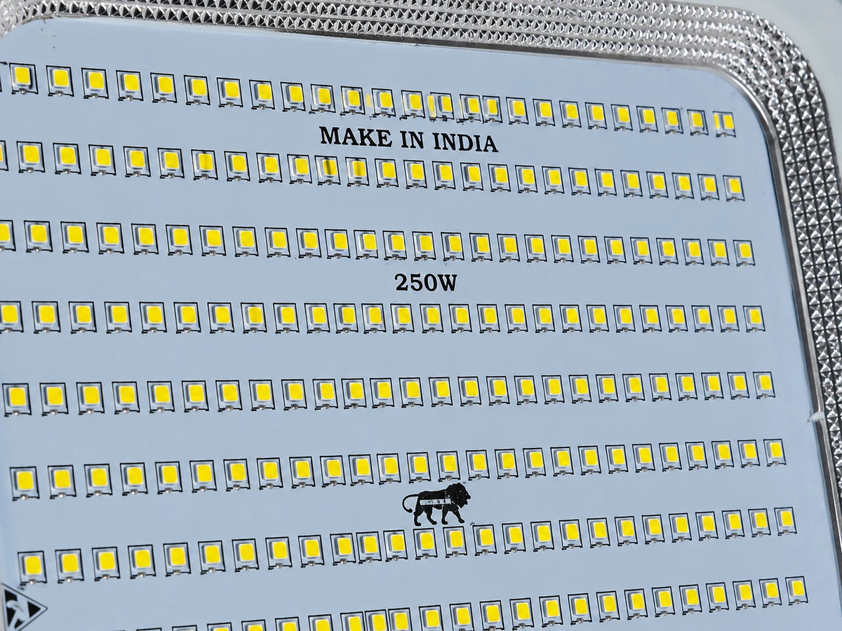 Close-up of a high-power LED light panel with rows of small yellow LED chips on a silver base, featuring 'MAKE IN INDIA' and '250W' text printed on the surface.