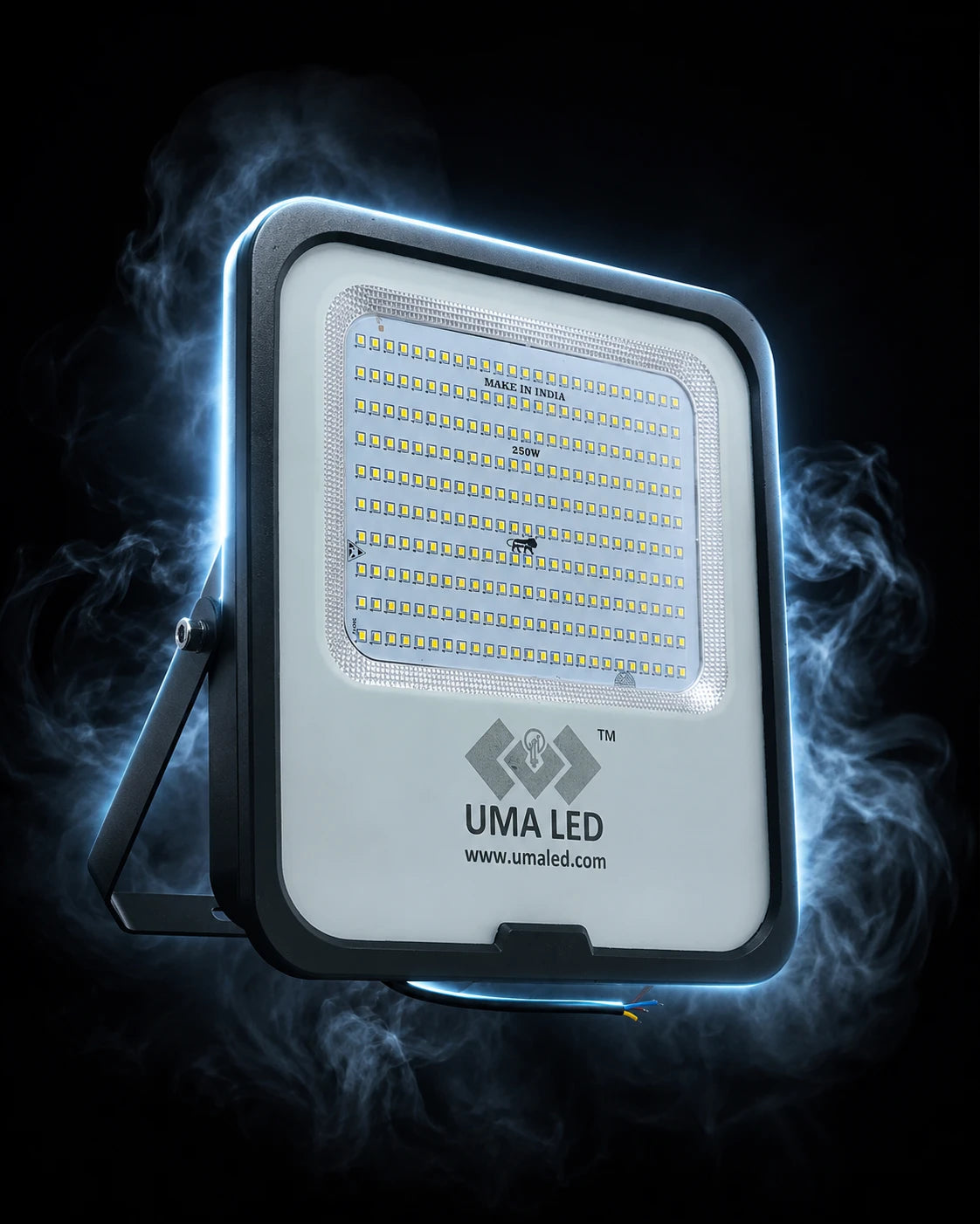 UMA LED square outdoor floodlight with a white faceplate, black frame, and integrated mounting bracket, shown against a dark background with dramatic blue light glow and smoke effects.