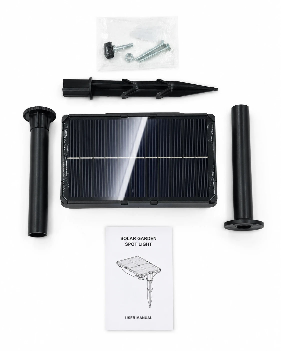 Solar garden spot light kit laid out on a white background, including a rectangular solar panel, two black ground stakes, mounting hardware in a small plastic bag, and a user manual.