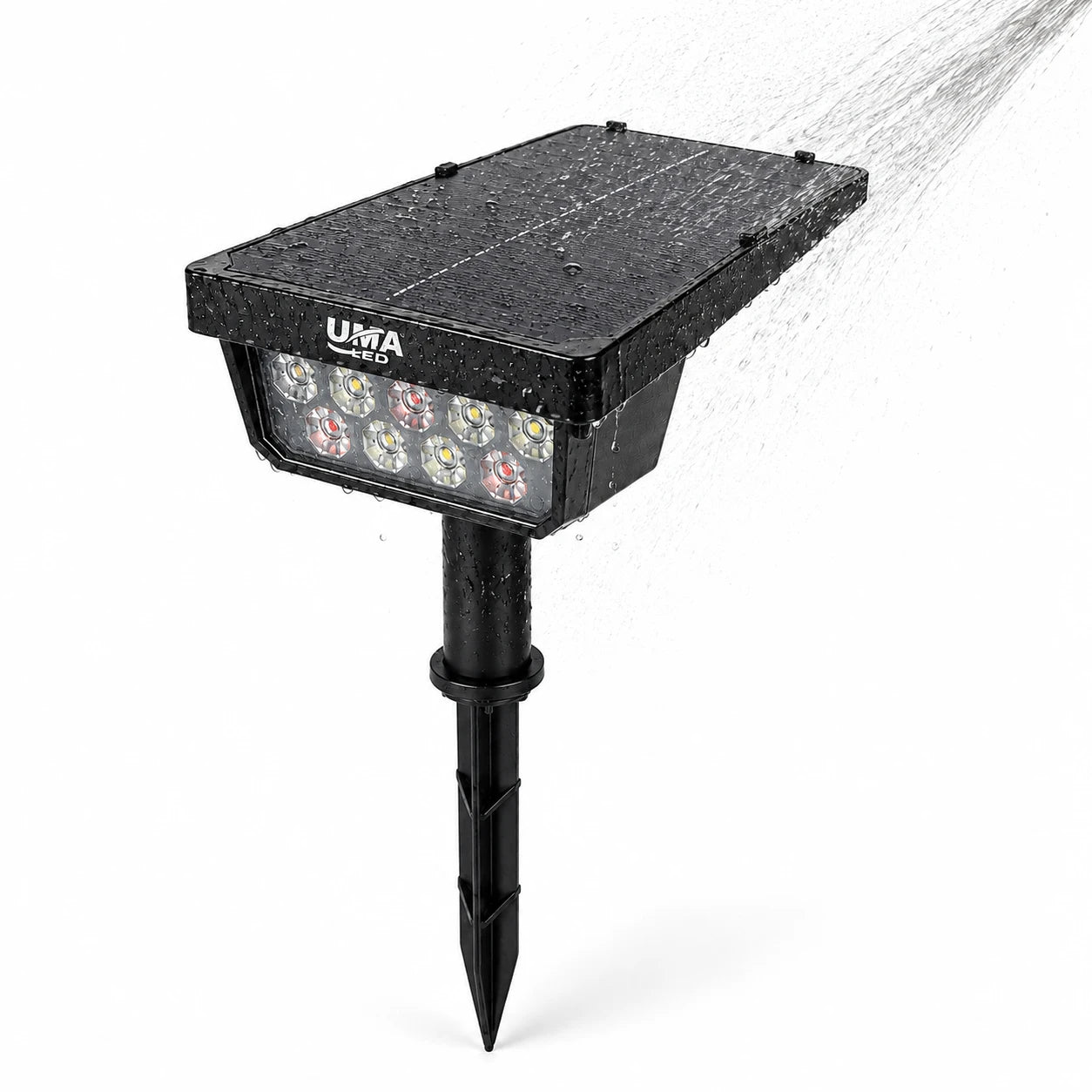 Black solar-powered LED garden stake light with water spraying over it, shown on a white background. The UMA brand name is visible on the top of the housing.