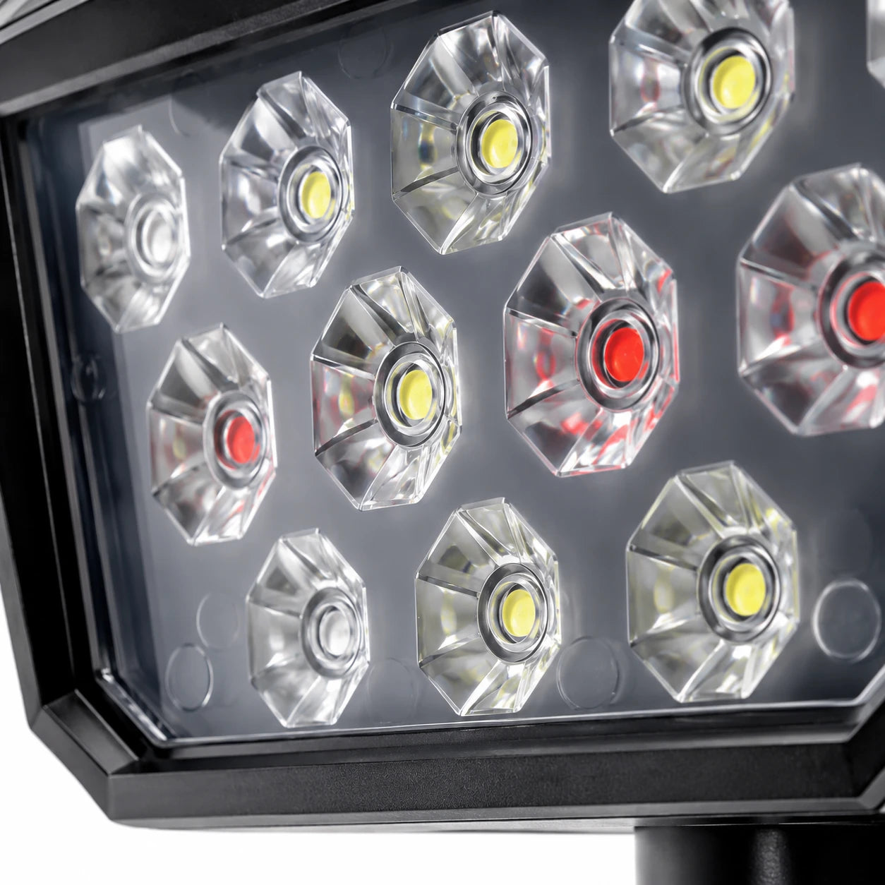 Close-up of a black LED light fixture showing multiple faceted clear reflectors with yellow and red LED lenses inside.